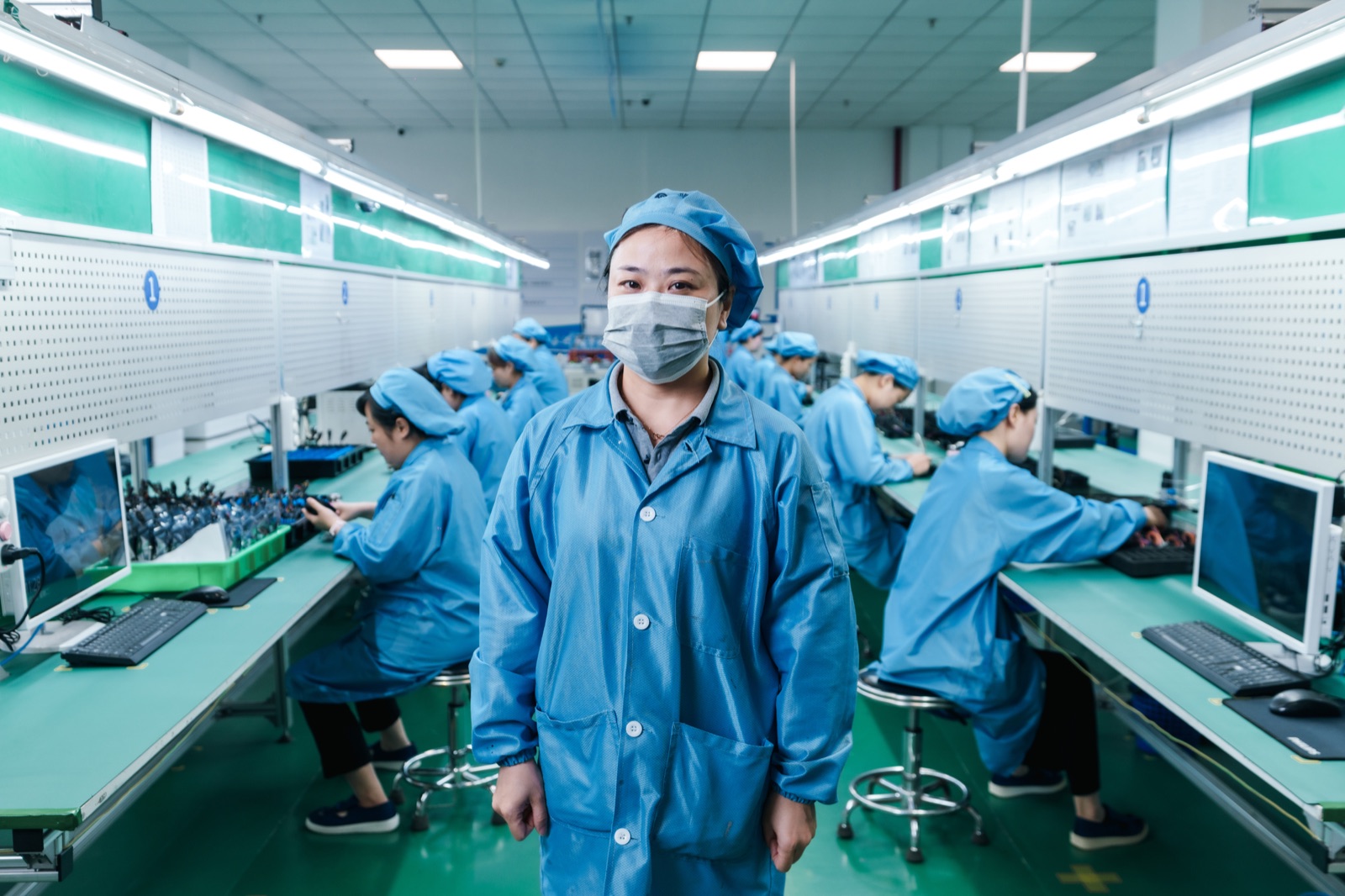 DC cooling fan assembly line with technicians performing quality-controlled production of military-grade fans